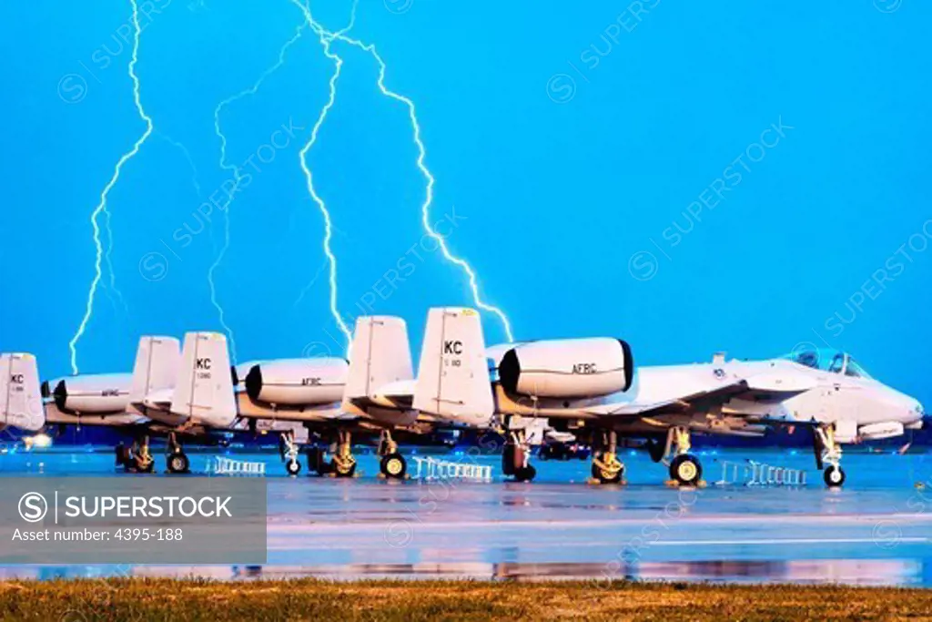 Lighting strikes behind A-10 Thunderbolt IIs on the Whiteman Air Force Base, Mo., flightline during an early morning thunderstorm Oct. 20, 2009. The 442nd Fighter Wing maintains a fleet of 27 A-10s. (U.S. Air Force photo/Senior Airman Kenny Holston)