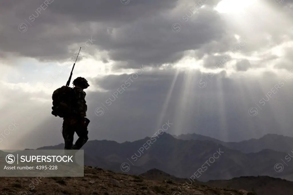 U.S. Army Spc. Newton Carlicci travels dismounted while on his way back to his outpost from the village of Paspajak, Charkh District, Logar province, Afghanistan, June 20. Carlicci and his platoon went to this village in order to check on conditions by communicating with the locals.