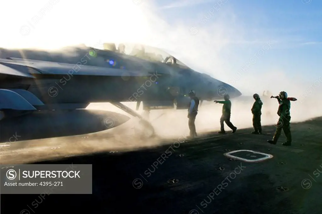 Sailors conduct preparations for launching an F/A-18F Super Hornet belonging to the Black Knights of Strike Fighter Squadron (VFA) 154 from a steam-powered catapult on board the nuclear-powered aircraft carrier USS Ronald Reagan (CVN 76).  Steam-powered catapults are capable of launching aircraft off the flight deck in under two seconds.