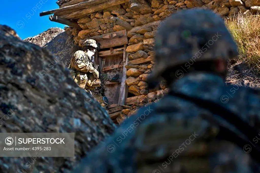 KUNAR PROVINCE, Afghanistan - U.S. Army Spc. Nathan H. Willett (foreground), a team leader from Lynn, Ark., provides security for U.S. Army Spc. Christopher W. Childs, an M249 squad automatic weapon gunner from Garland, Texas