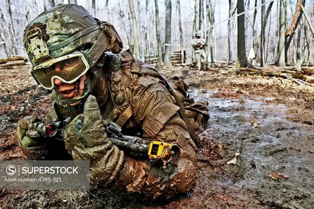Crawling through mud, Pvt. Charles Shidler, Alpha Company, Special Troops Battalion, 37th Infantry Brigade Combat Team, Ohio National Guard, searches for the next covered fighting position during individual movement techniques training at the Camp Ravenna Joint Maneuver Training Center, Ravenna, Ohio, April 17.