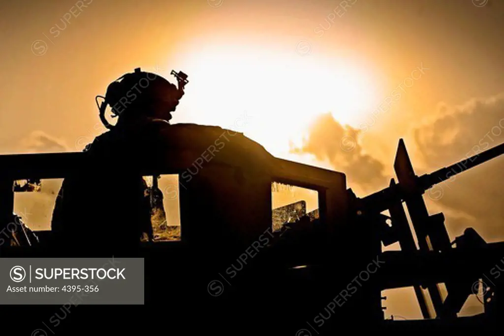 Spc. John 'Rocky' Montoya, M2 gunner attached to Laghman Provincial Reconstruction Team, scans his sector of fire while on a combat patrol to sweep for roadside bomb triggermen in Alingar District, Laghman Province, Aug. 8. The PRT is serving as the Quick Reaction Force, ready to respond at a moment's notice to unexpected incidents in the province.