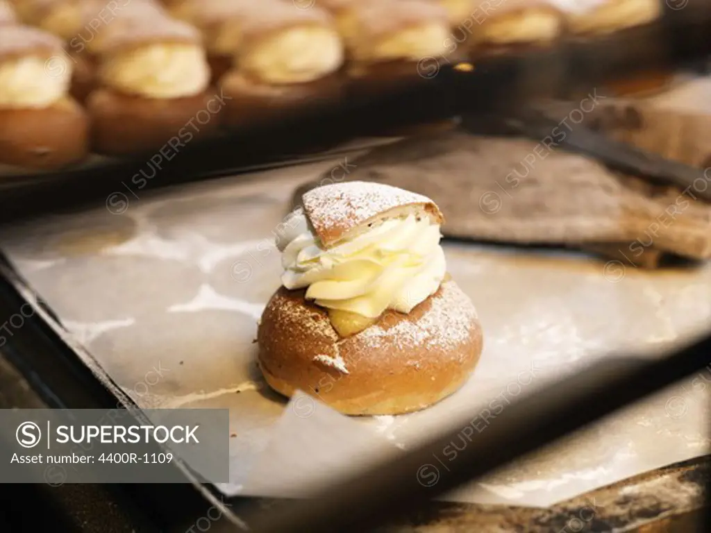 Cream buns with almond paste on a baking plate, Sweden.