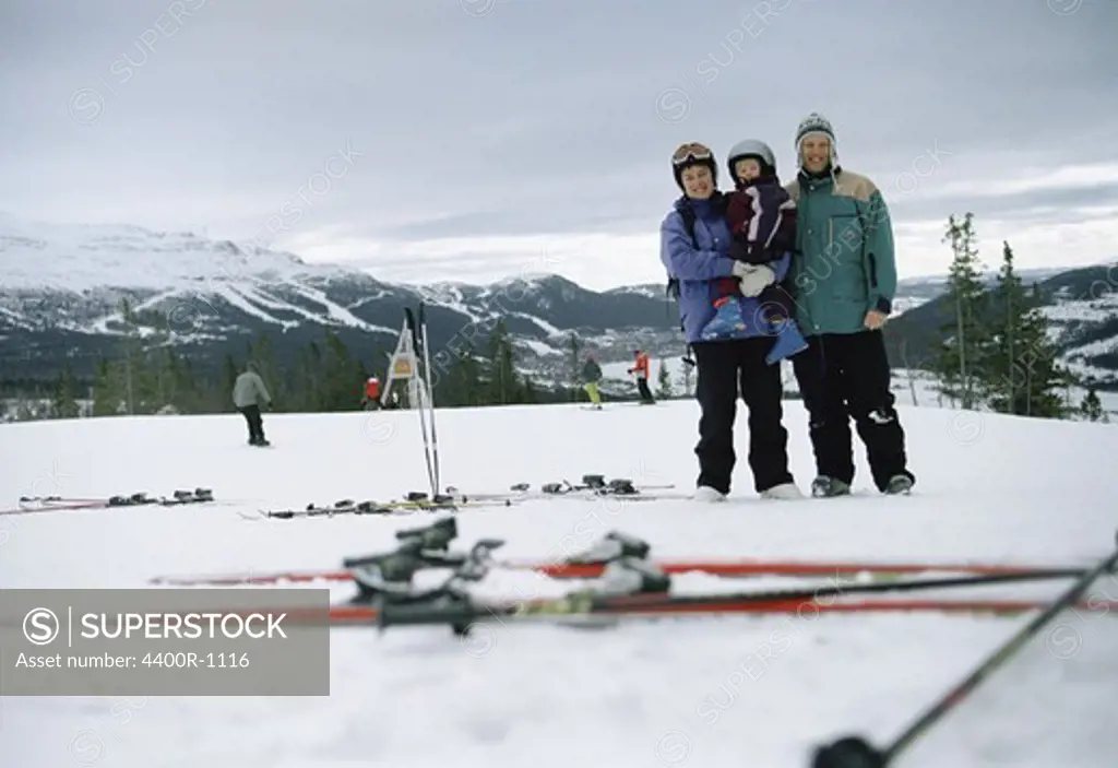 A family in a ski slope.