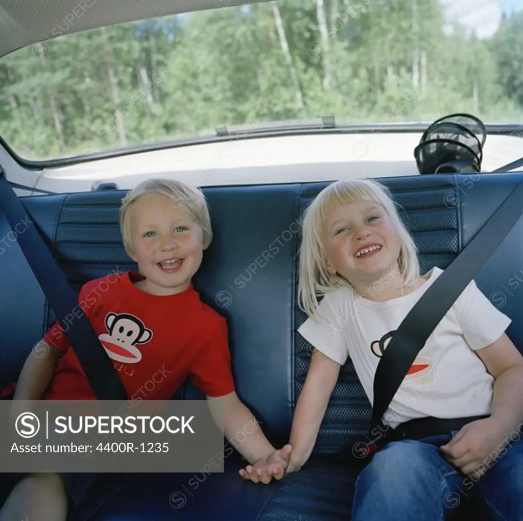 Two children in the back seat, Sweden.