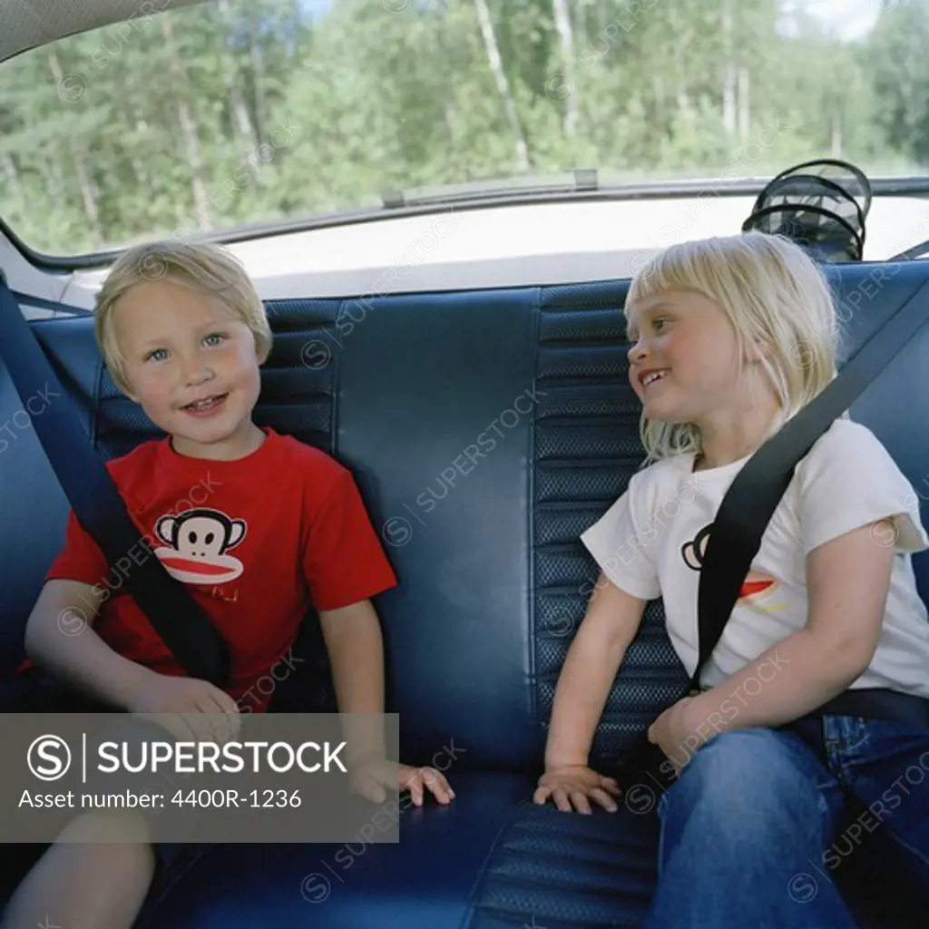 Two children in the back seat, Sweden.