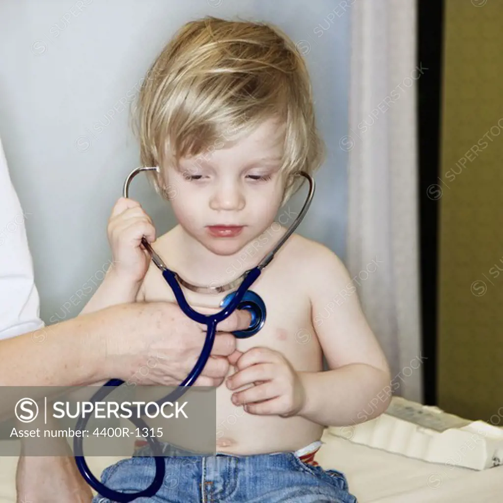 A boy using a stethoscope, Sweden.