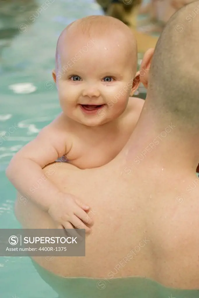 A smiling baby on baby swim, Sweden.