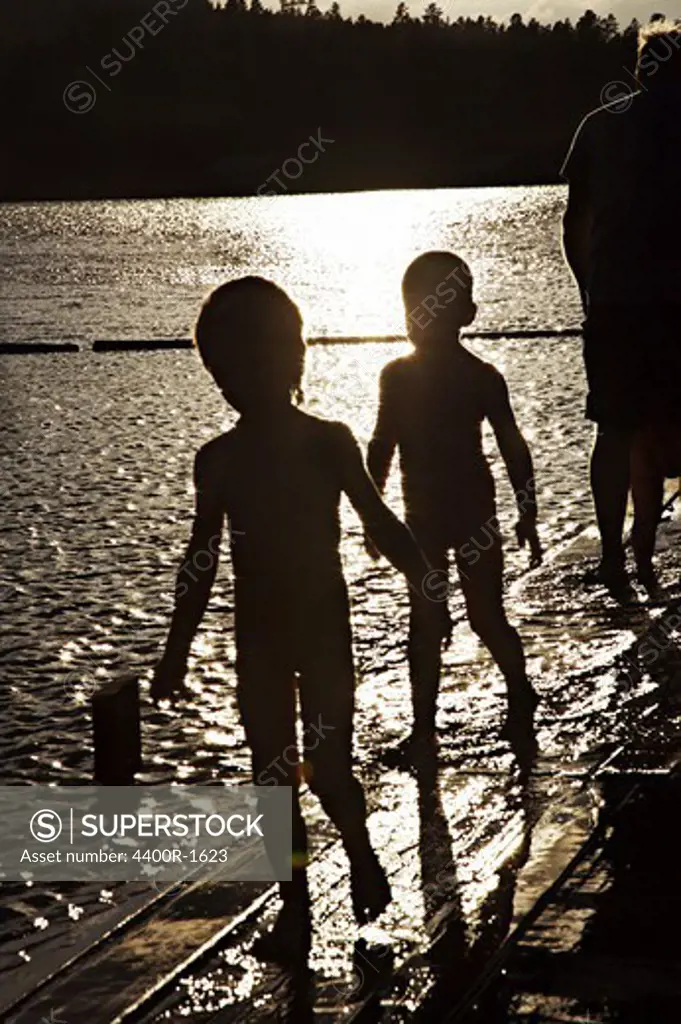 Two children playing in the water, Angermanland, Sweden.