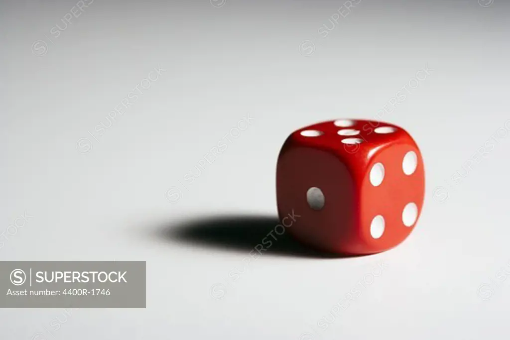 A red dice against white background.