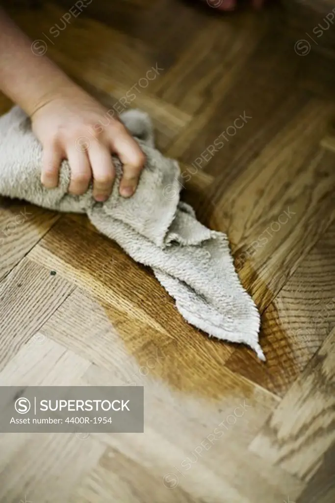 The hand of a boy cleaning the house, Sweden.