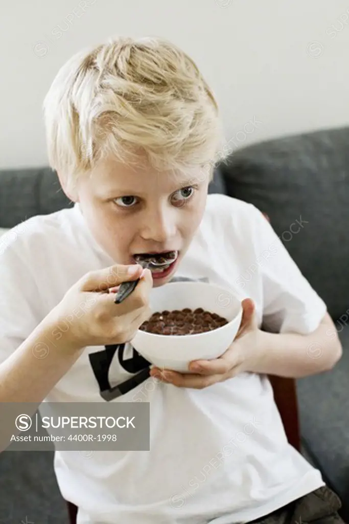 Boy eating cereal, Sweden.