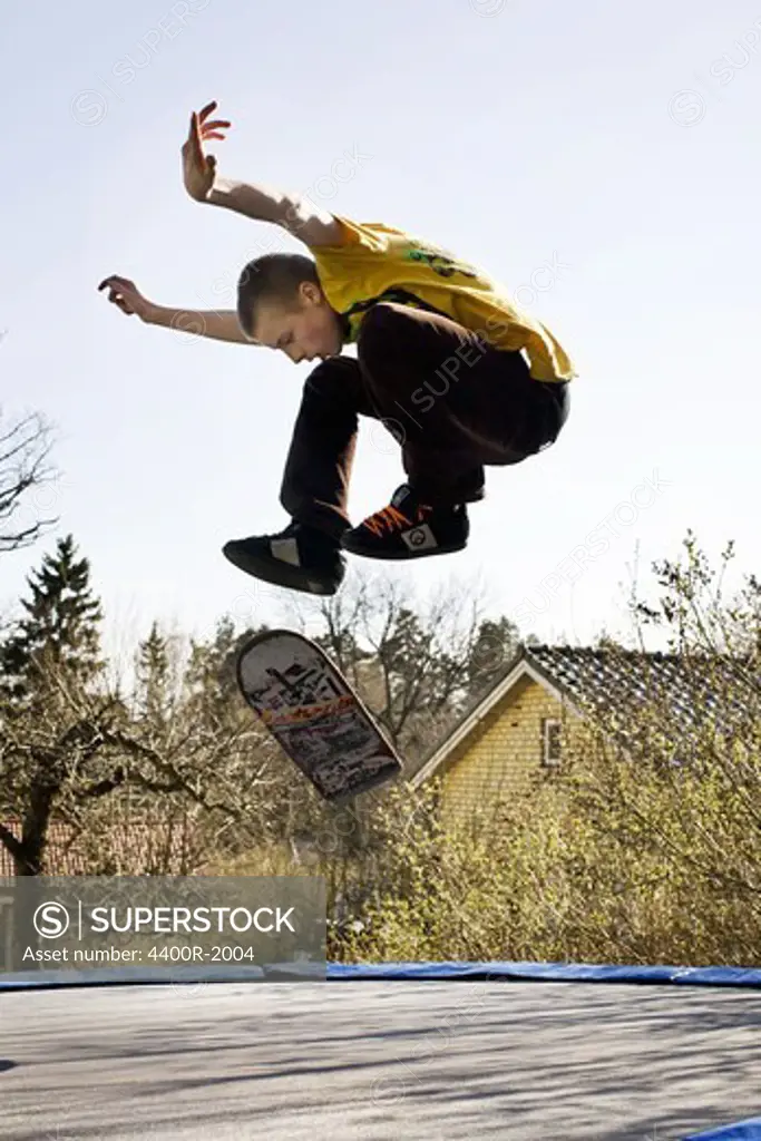 Boy jumping on a trampoline, Sweden.