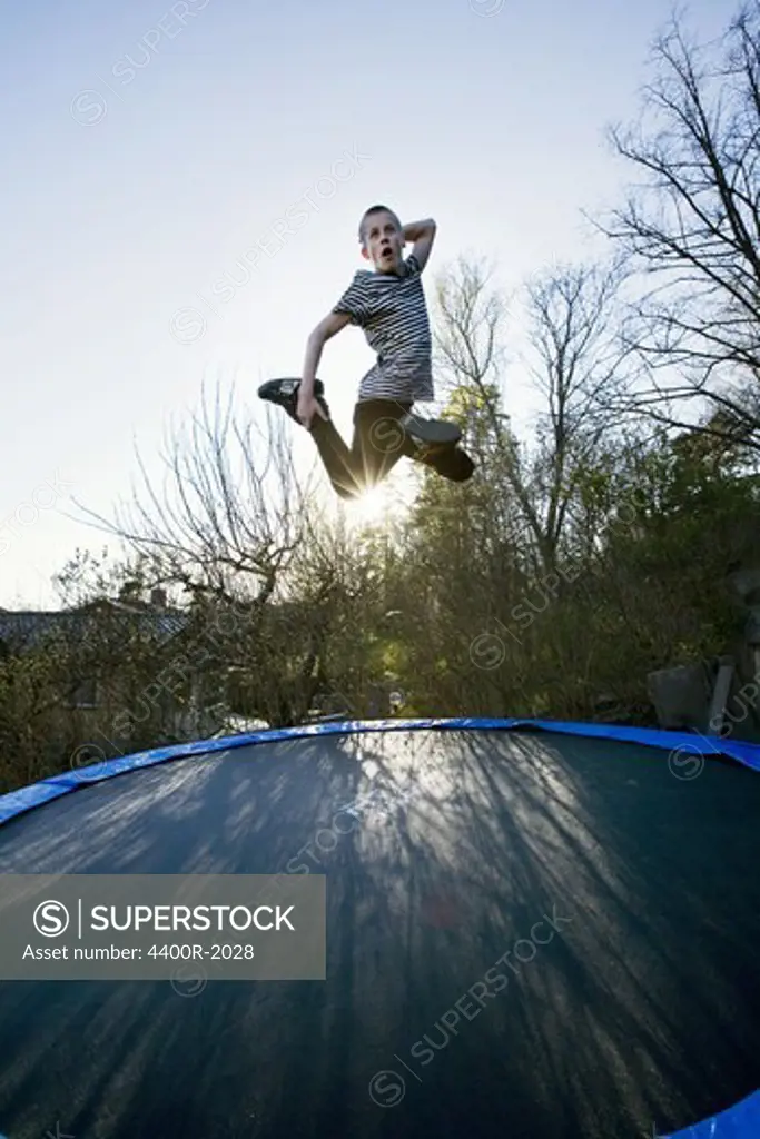 Boy jumping on a trampoline, Sweden.