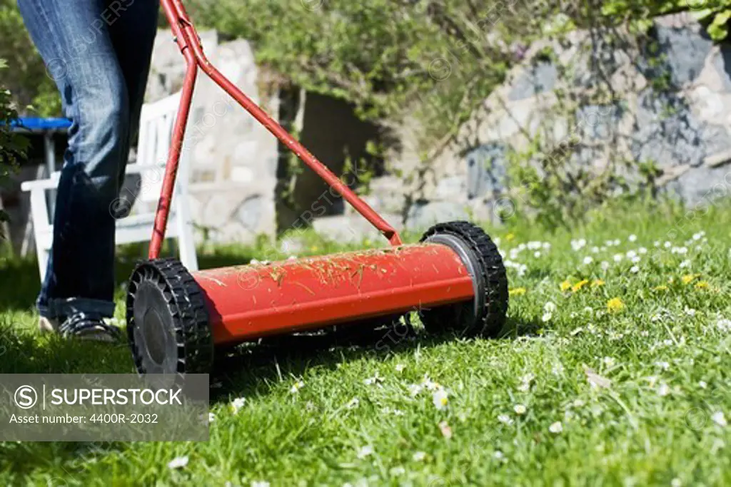 A woman moving the lawn, Sweden.