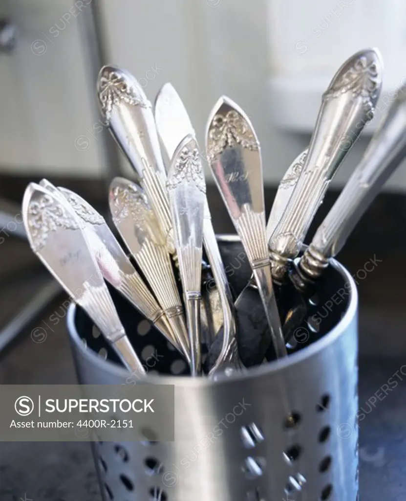 Silver cutlery in steel container