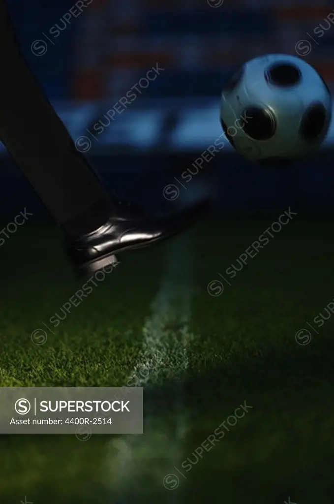 A black shoe and a football.