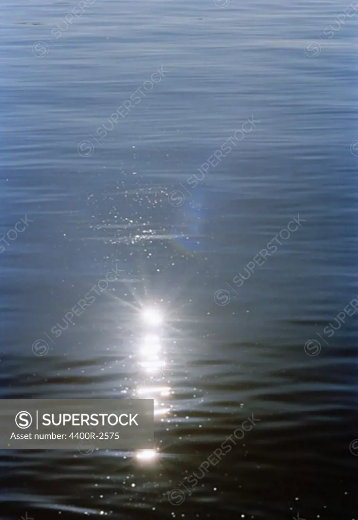 Sun reflected on the surface of the water, Sweden.