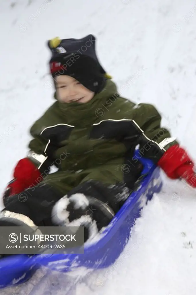 A boy on a little sledge, Sweden.