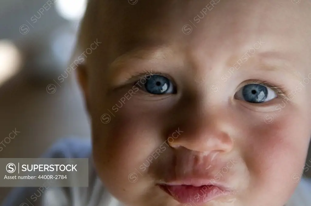 Portrait of a baby with a running nose, Sweden.