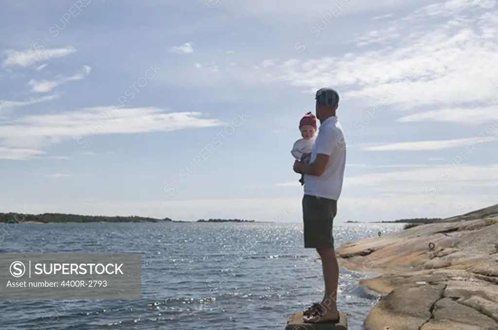 Father with children by the sea, Sweden.
