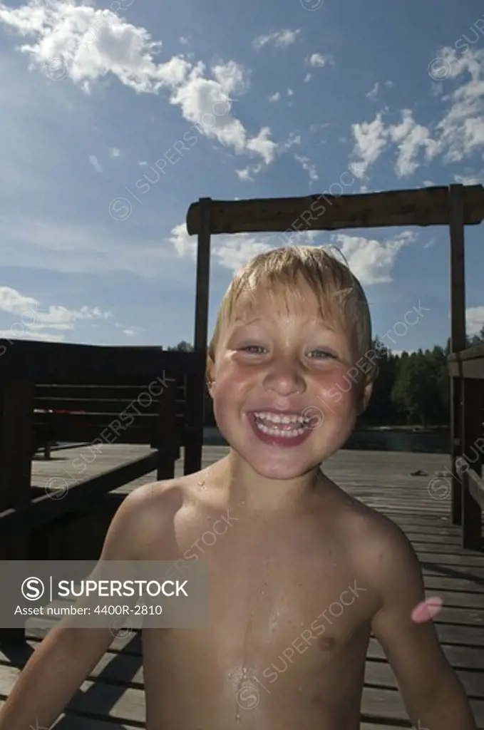 A happy boy on a jetty, Sweden.