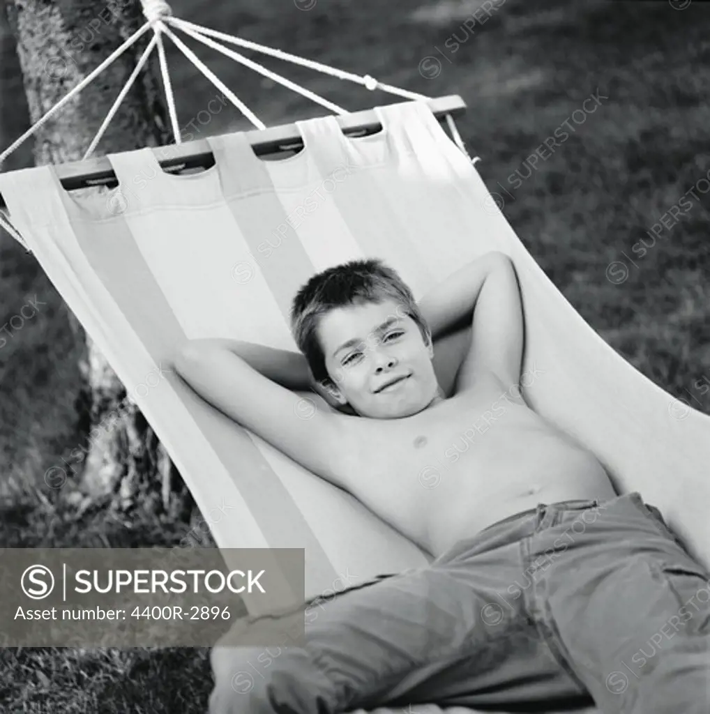 Portrait of a boy resting in a hammock, Sweden.