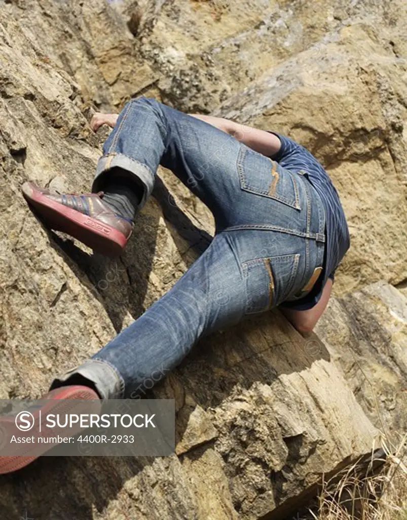 A man climbing a rock-face, Sweden.