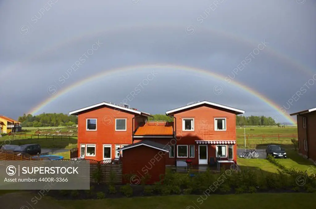 Rainbow over houses, Sweden.