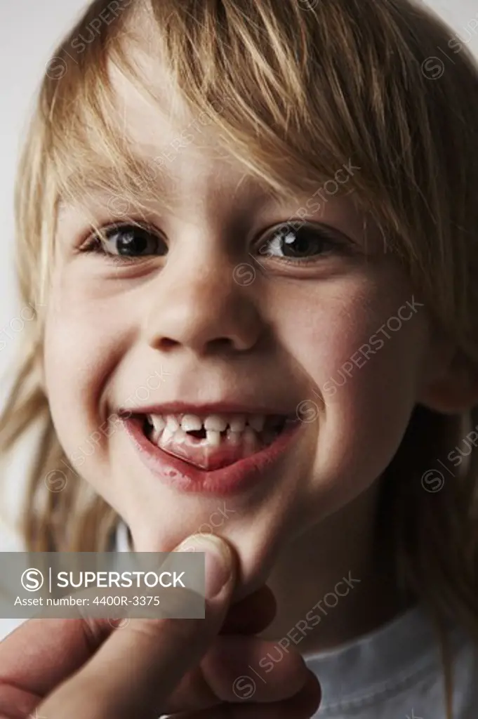 Portrait of a boy missing a tooth.