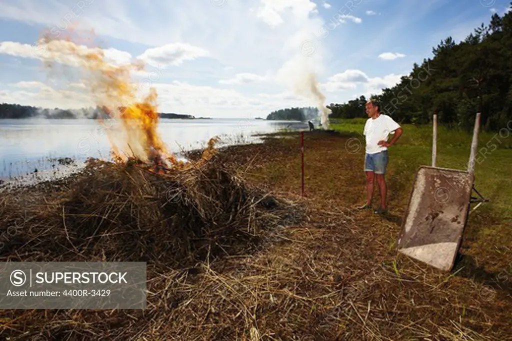 A man burning reed, Sweden.