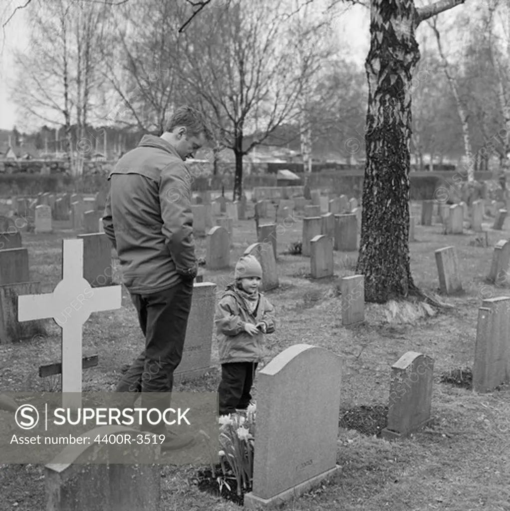 Father with daughter on graveyard