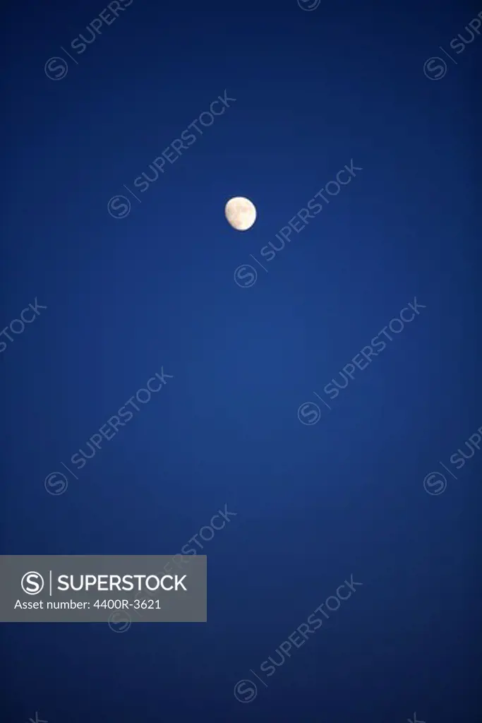 A moon on the dark blue sky.