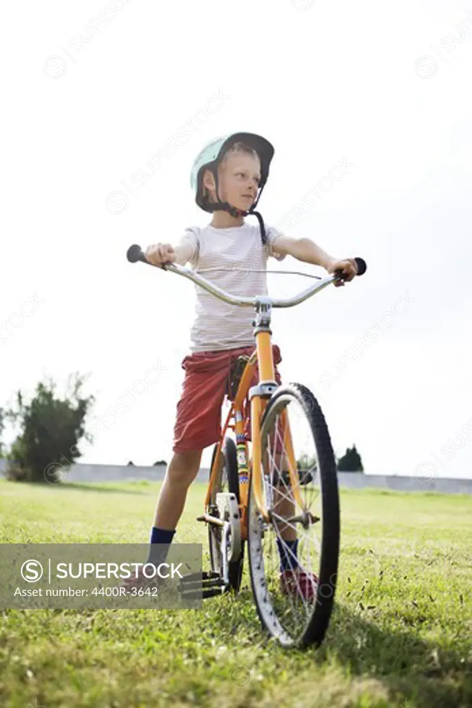 Boy on bicycle in field