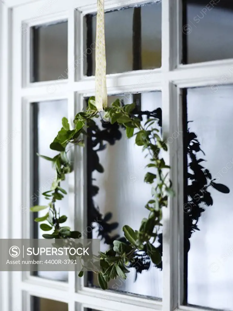 A garland hanging in a window.