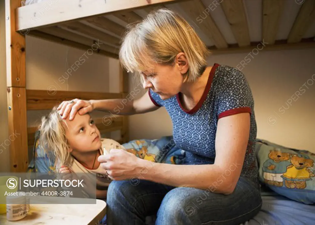 Mother taking care of sick daughter, Sweden.
