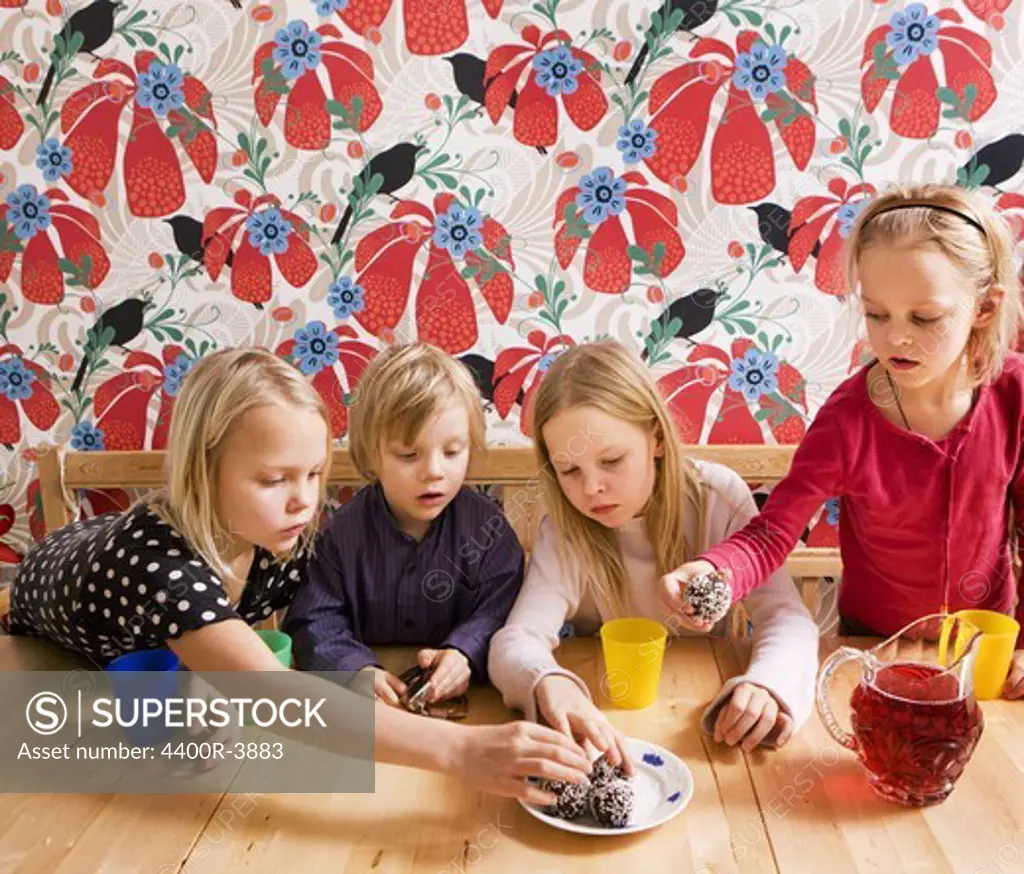 Children eating cookies, Sweden.