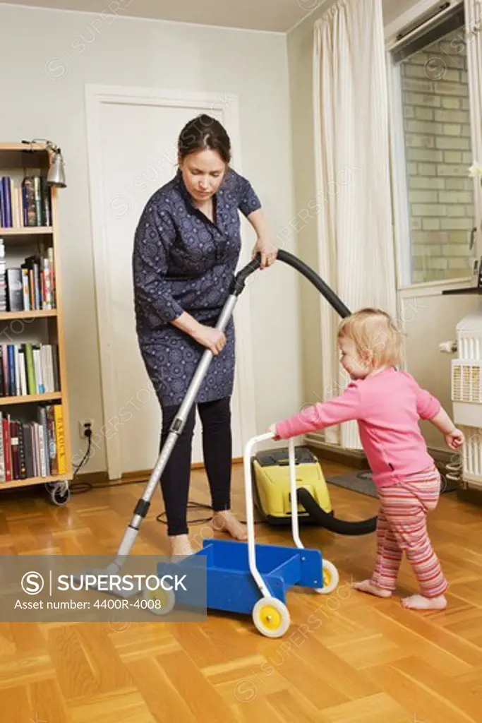 A woman vacuuming, Sweden.