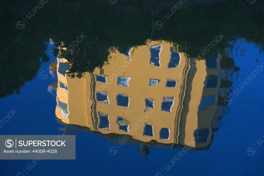 A block of flats reflected on the surface of water, Sweden.