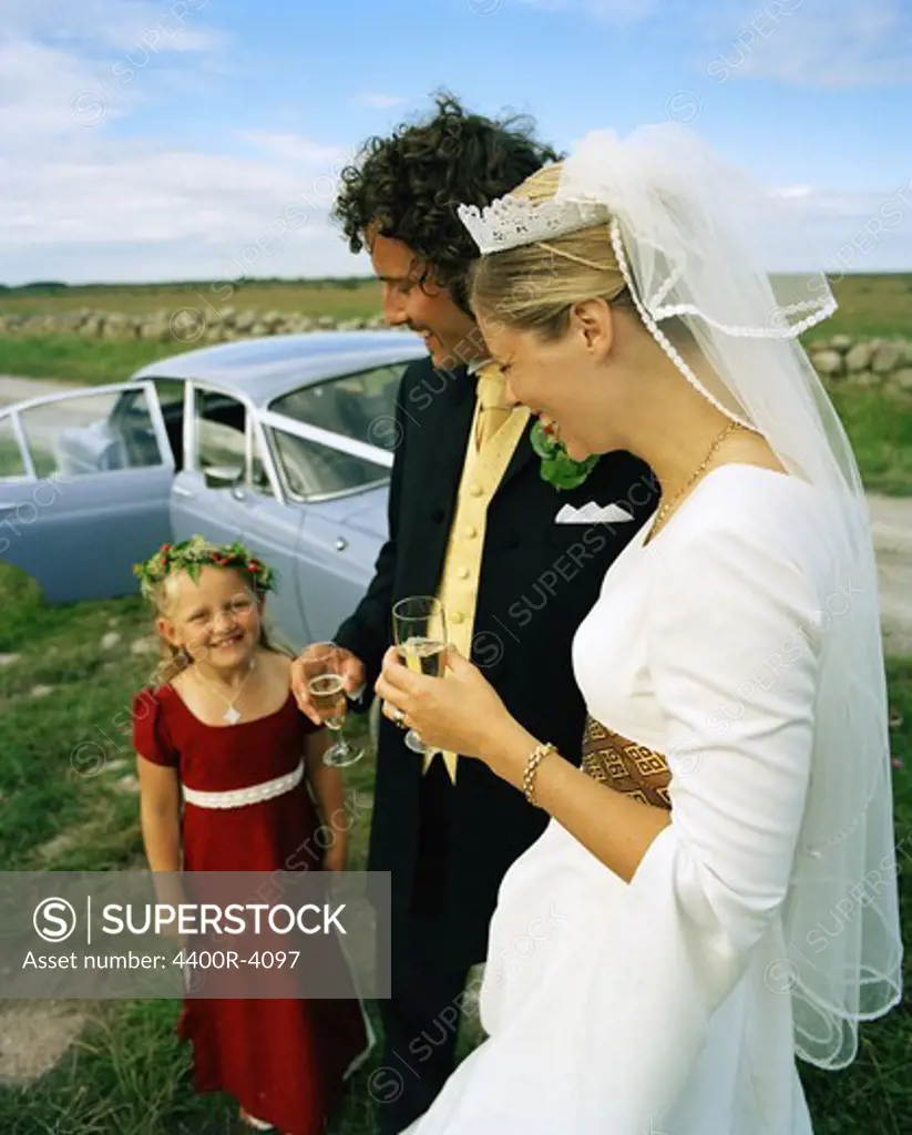 Scandinavia, Sweden, Oland, Bride and groom with flower girl, smiling