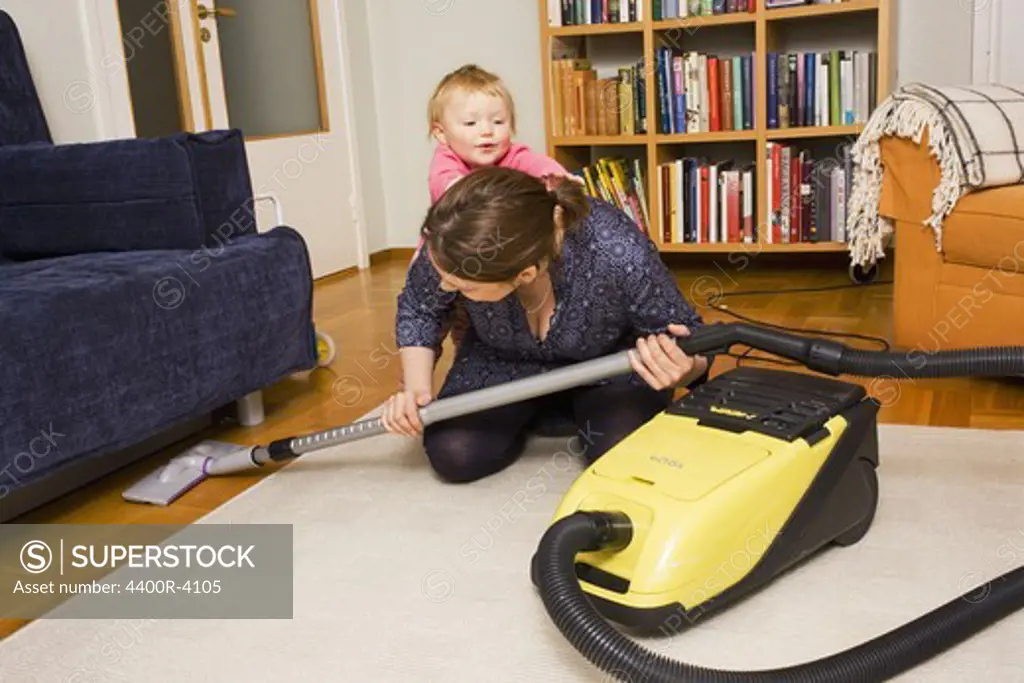 A woman vacuuming, Sweden.
