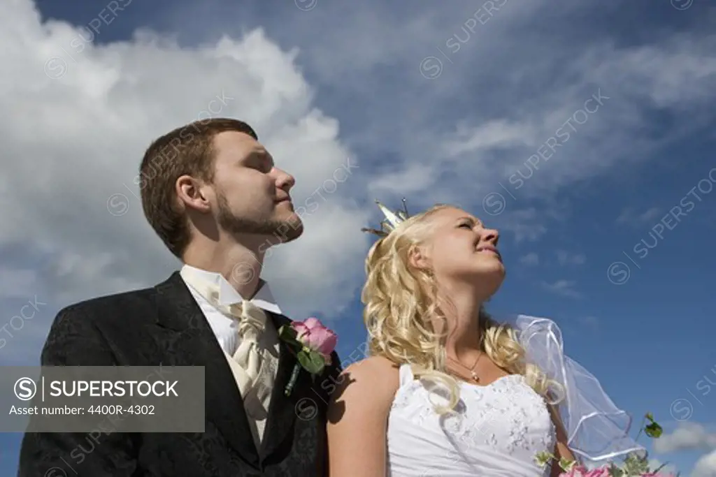 Bride and groom looking up towards sky