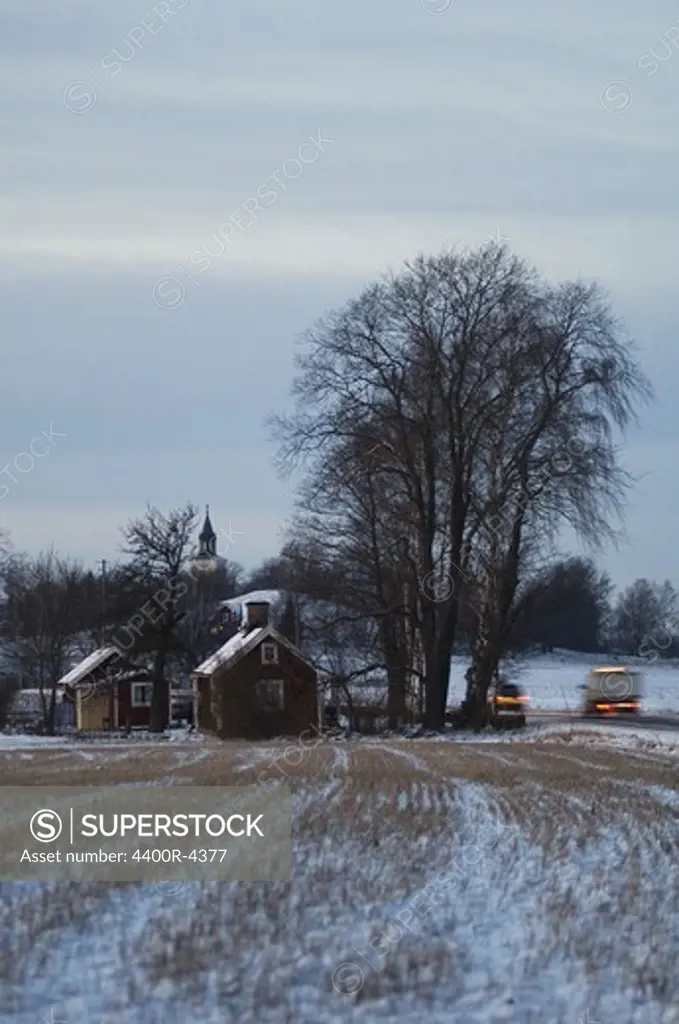 View of cars and houses on winter landscape