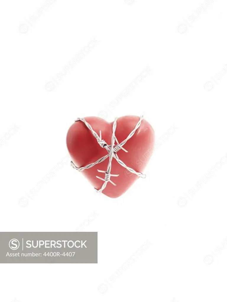 Barbed wire around a red heart.
