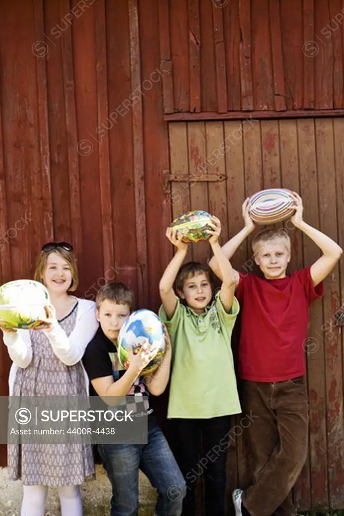 Children holding big Easter eggs