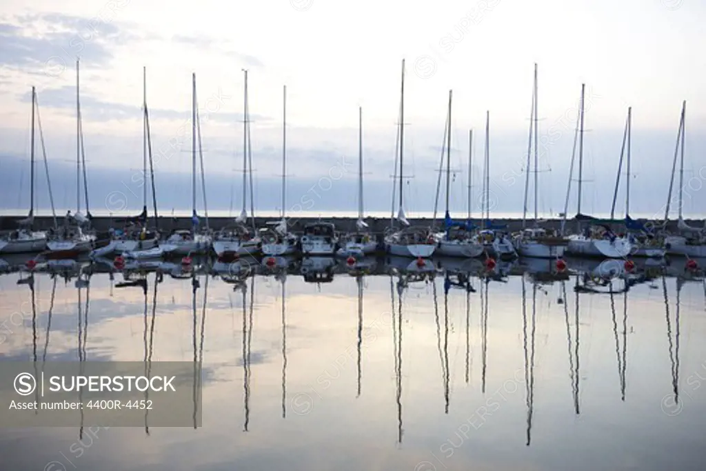 View of sailing boats with reflection in water