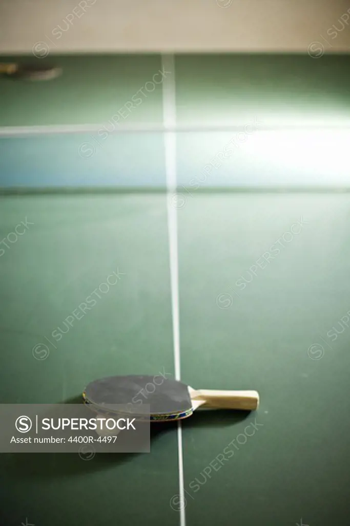 Table tennis bat with ball on table