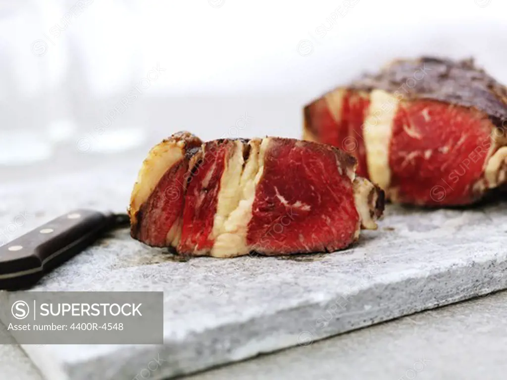 Close up of red meat slices on cutting board