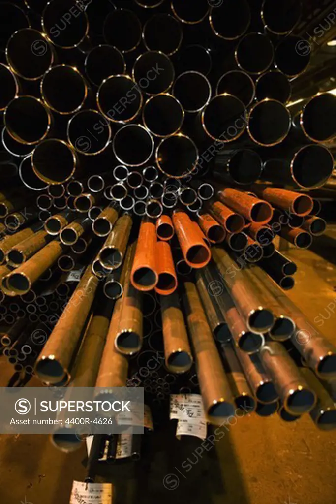 Stack of steel pipes in factory