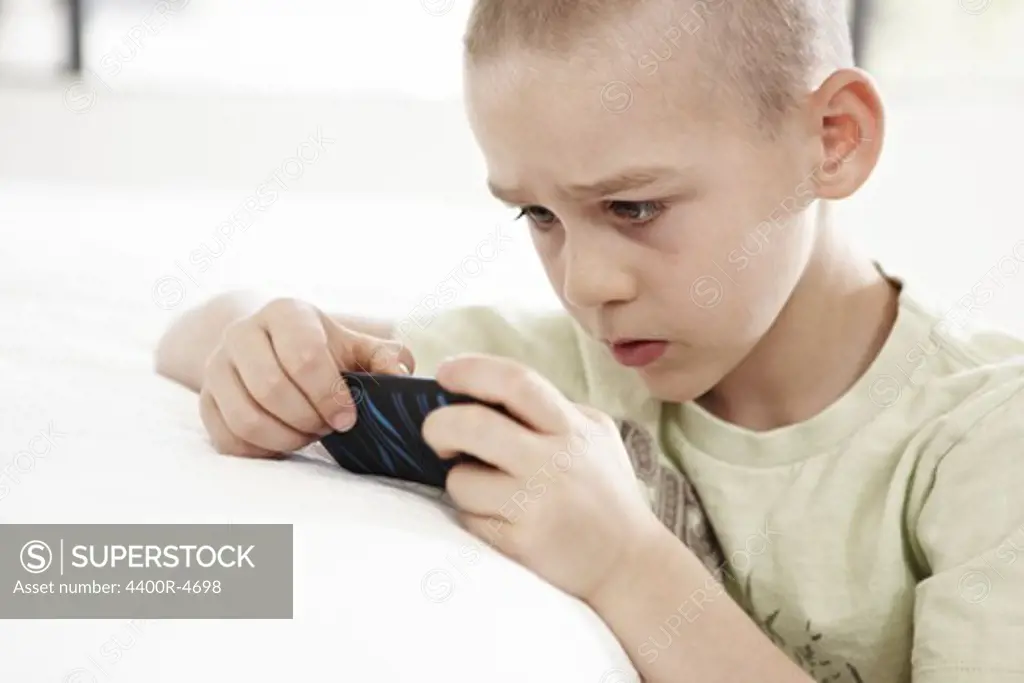 Boy playing games on MP3 player